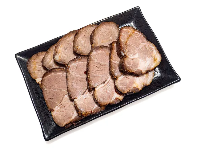 Sliced Japanese chashu at Niku no Takasago. Actual sliced Japanese cooked pork from Niku no Takasago, Tsukishima. Recipes and cuts vary; this is not Chinese red-glazed char siu used as a substitute.