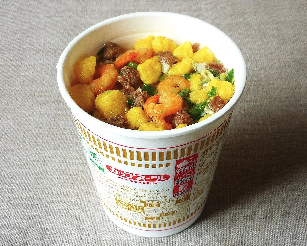 Nissin CUPNOODLES, original flavor. An actual original-flavor CUPNOODLES product photographed in Japan. This modern product photograph is not the original 1971 packaging.