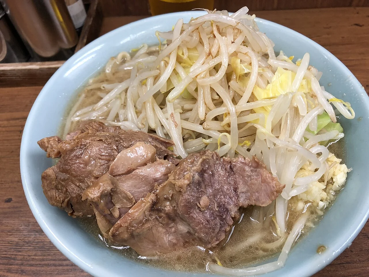 A karame order at Ramen Jiro Ikebukuro. The original description records a small pork ramen order with yasai, karame and less garlic at Ramen Jiro Ikebukuro. The stronger-seasoning request is documented by the source, not inferred from the soup’s color.