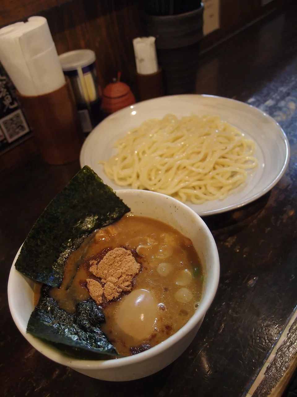 Noodles and chicken-fish dipping broth in separate bowls at Fuunji Shinjuku.