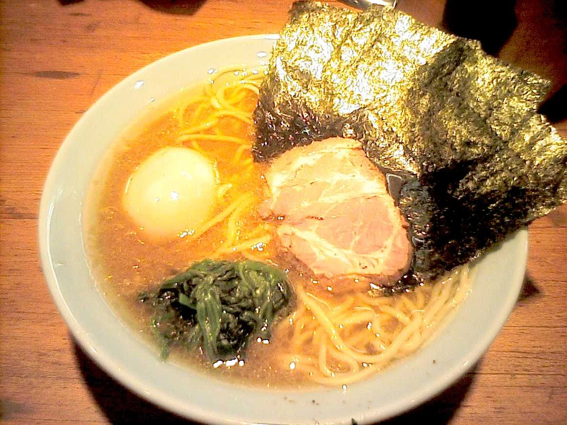 Iekei ramen with seaweed sheets, spinach, egg and sliced pork.