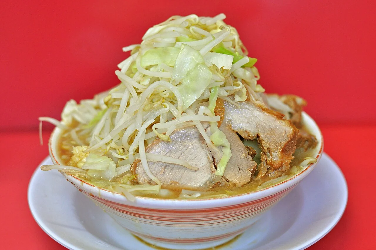 A tall mound of bean sprouts and cabbage over pork and ramen at Jiro Omiya in 2014.